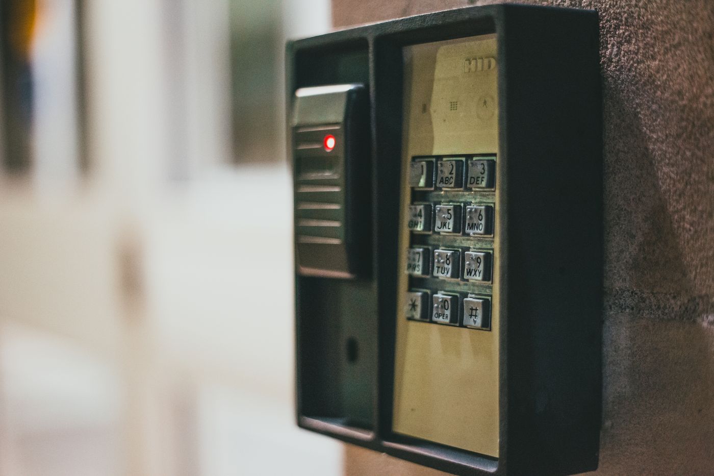 Electronic entry keypad beside a building entrance