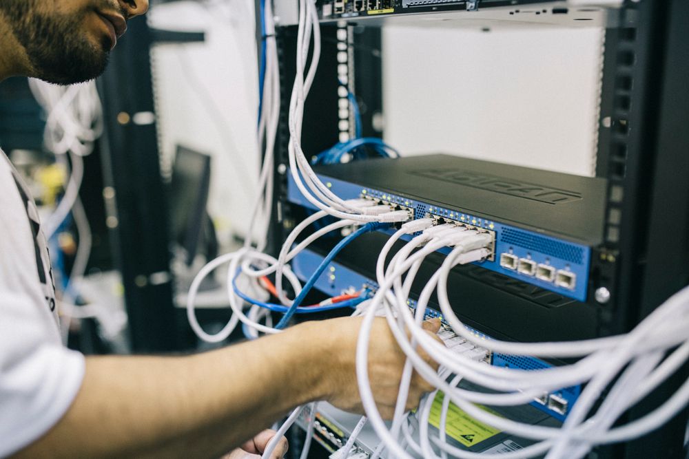 Technician working on network cabling