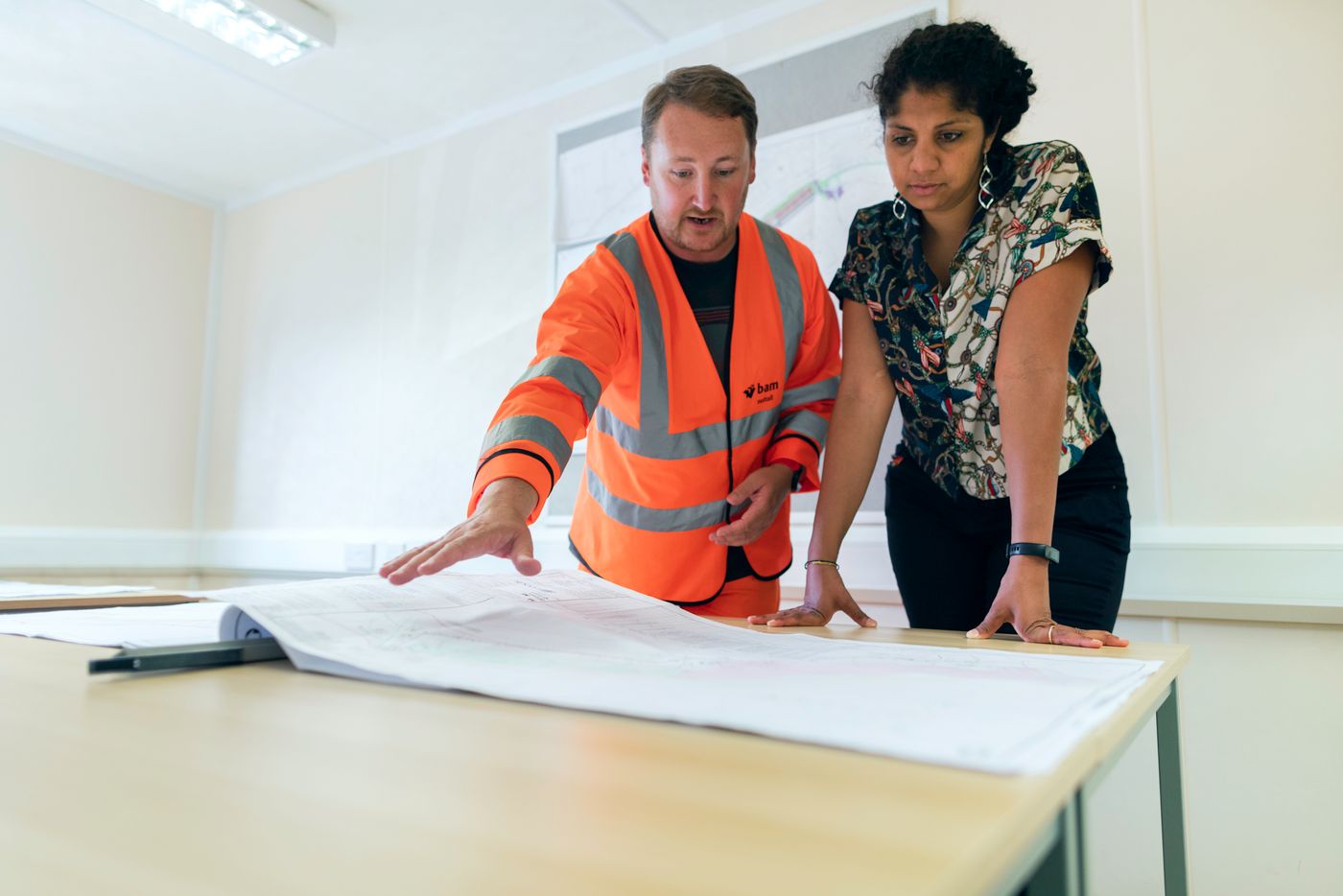 Professionals reviewing plans at a project site